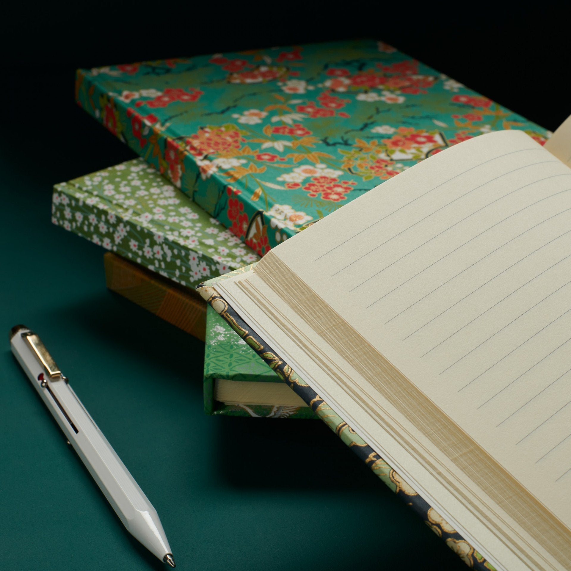 Put pen to paper with this A5 lined Essential notebook, whether scribbling down ideas and inspirations, or just simple reminders for the week ahead. Featuring 72 lightweight smooth lined leaves, sourced from a paper mill in Italy, this wonderfully portable slimline hardback notebook is ideal as your everyday companion. This notebook features over seven colours, the pistachio green, burgundy red & vibrant coral florals pop against a cool cornflower blue background. 