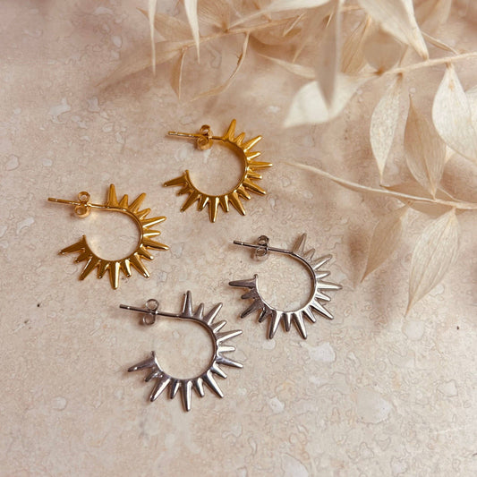 Mini Sol Hoops. A pair of gold or silver hoops with a sun ray detail