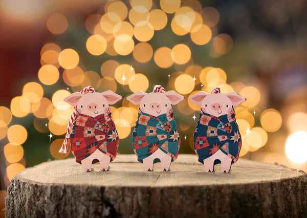 Hand designed wooden decoration, perfect for Christmas. Who doesn't love pigs in blankets. This little piggy is looking very cosy wrapped up in patterned blanket. Made from sustainably sourced maple wood.