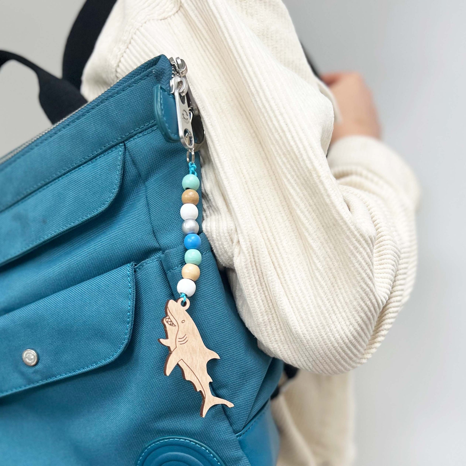 Shark key ring shown on a child's rucksack.