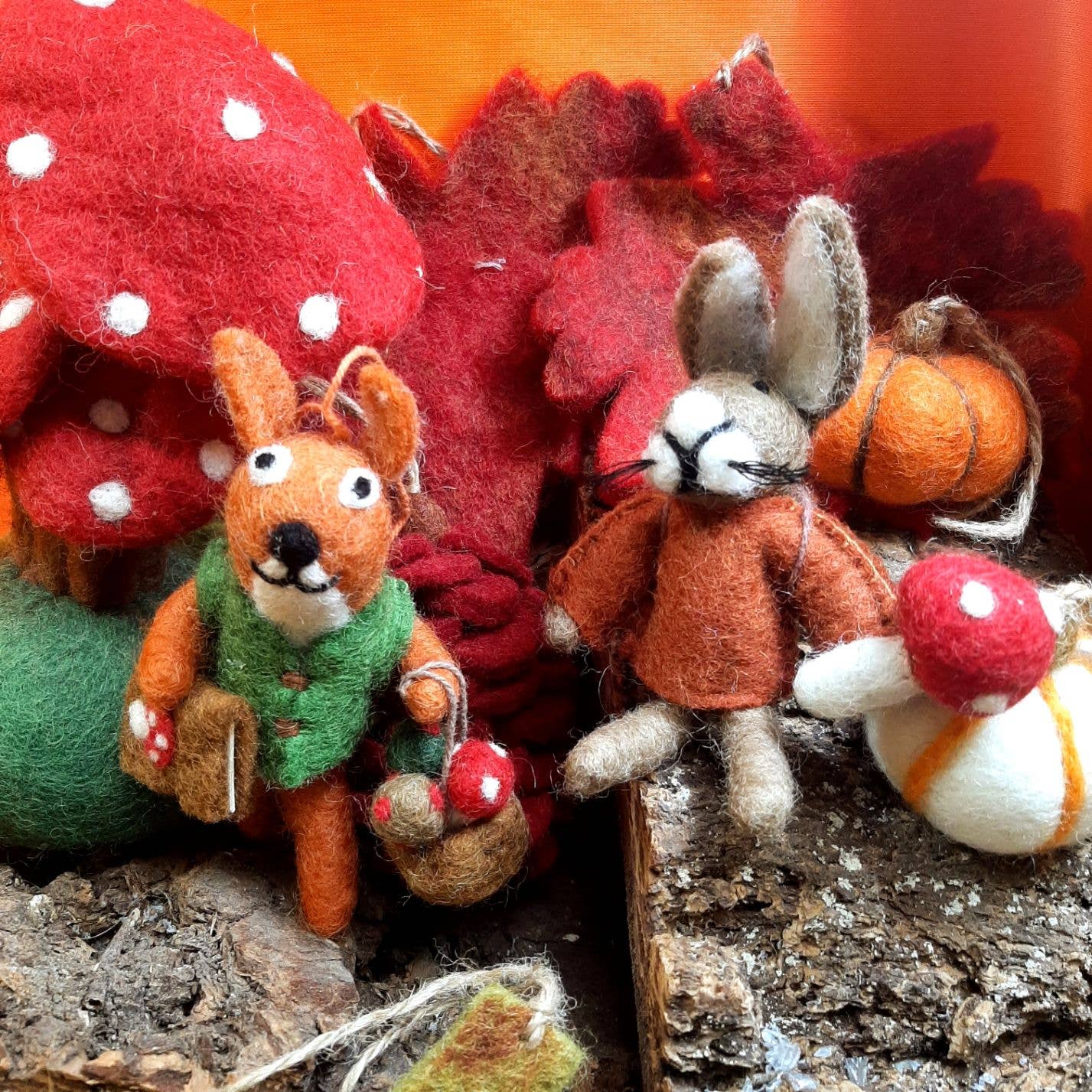 Handmade Felt Autumnal Russell the Hare Hanging Decoration. A hare in a rust coloured jumper, holding a toadstool.