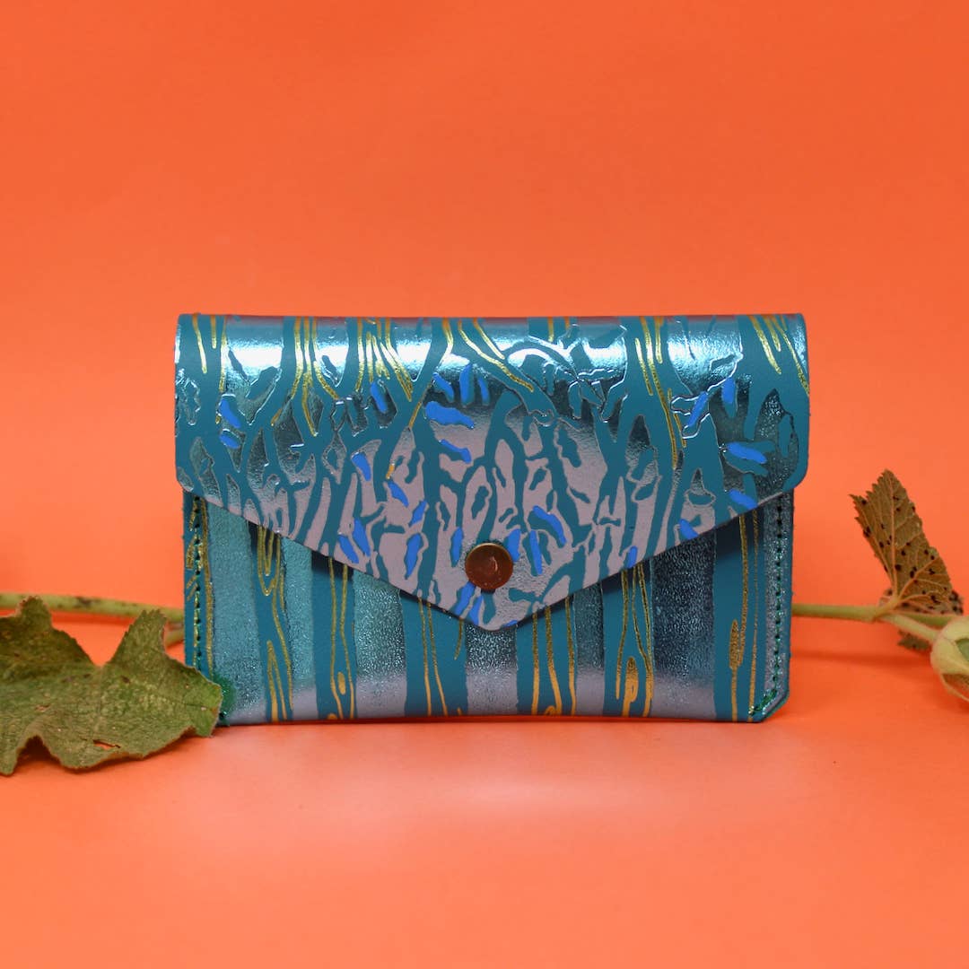 Introducing the newest addition to the Ark Colour Design collection - the Forest Popper Purse! Designed in our Cambridge studio and crafted in Scotland, they have created a striking embossed tree design which is designed to be practical and joyful. Individually hand embossed with both shiny and matte foil.