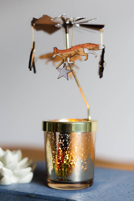 Rotating candle carousel with wooden etched foxes and stars. Which rotate when the candle is lit. Your Candle Carousel kit contains a glass votive, carousel attachment and four laser etched wooden ornaments, intricately hand painted and embellished with a sparkling details. Just add a standard tealight.