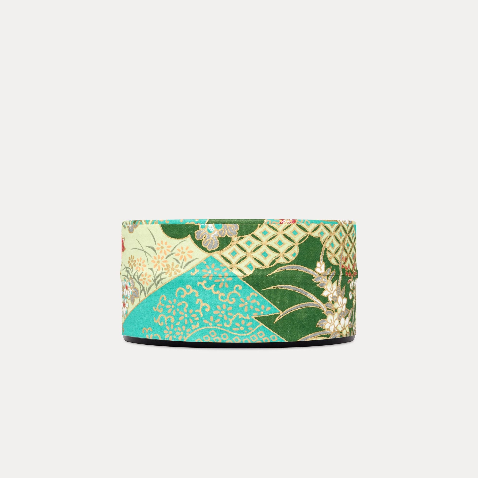 Turquoise Floral Keepsake Tin. An intricate patchwork of traditional Japanese pattern interspersed with beautiful florals, in a bold and vibrant turquoise with mint & burgundy accents. Each of our designs are selected from an archive of designs in Kyoto Japan, where we work with family-run silk screen print studios to produce our covering papers. This paper features a gold accent screen, that gives it that truly opulent finish.