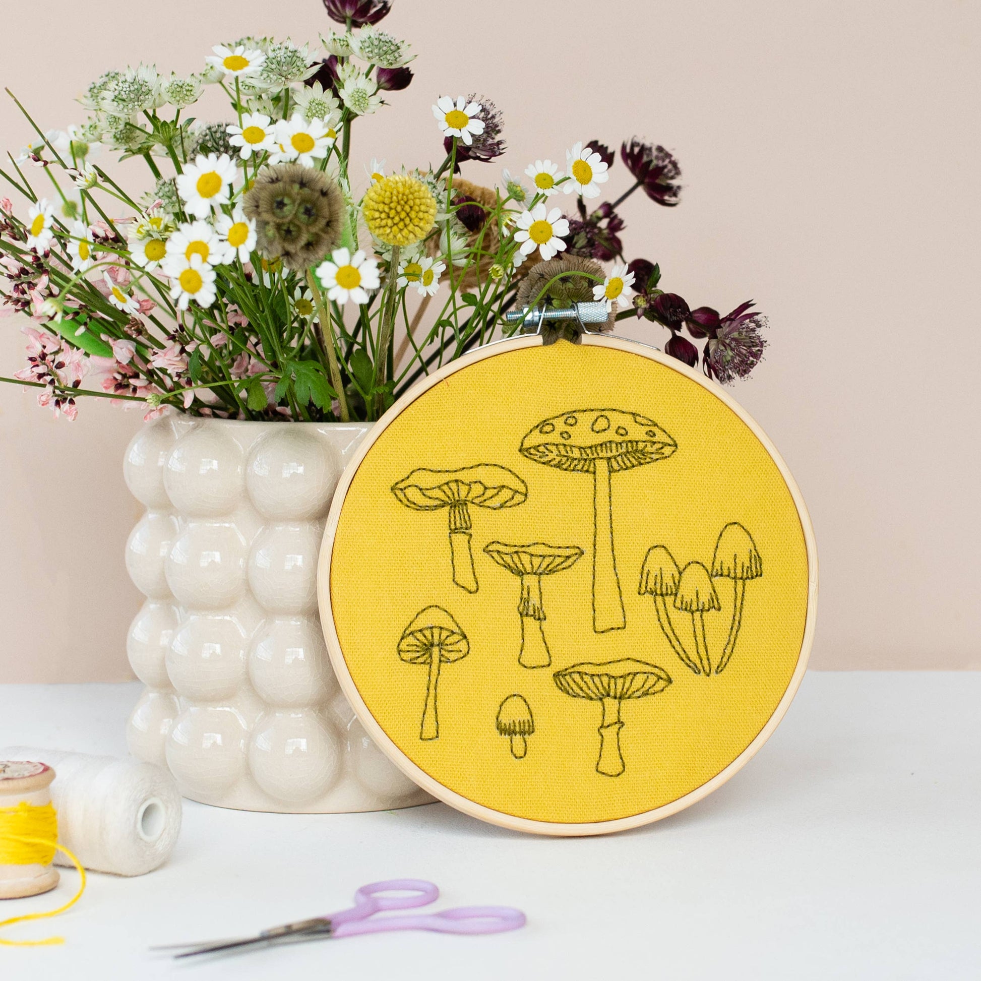 Yellow Fungi Embroidery Hoop Kit Kit by Cotton Clara. Featuring  seven different fungi's in black thread to embroider.