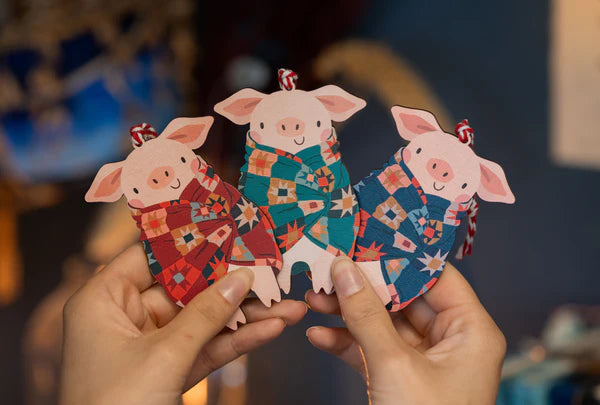 Hand designed wooden decoration, perfect for Christmas. Who doesn't love pigs in blankets. This little piggy is looking very cosy wrapped up in patterned blanket. Made from sustainably sourced maple wood.