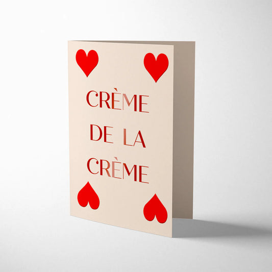  Red foiled onto natural white card, this card featured 4 red hearts in the design of a playing card. With the words Creme De La Creme written in capitals in red across the centre of the card.