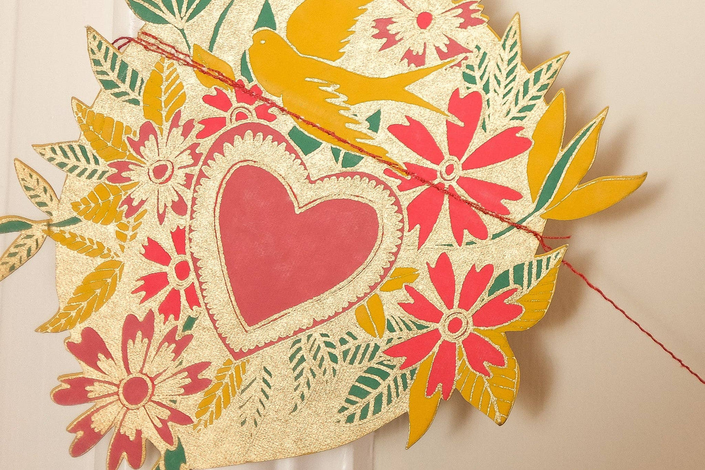 Inspired by scared hearts and Mexican folk art, this garland is full of kitsch and romance. Ten decorative, bejewelled hearts create the three metre garland.

Includes 10 paper shapes, sewn along strong cotton thread - Screen printed by hand on both sides by talented artisans in Jaipur - Sustainably made from recycled materials