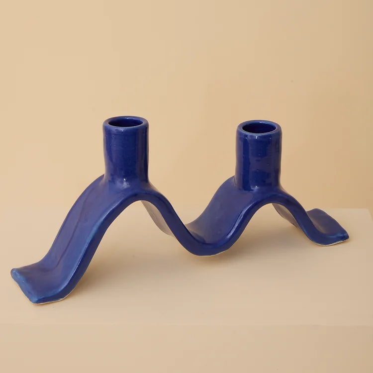 Handcrafted Small Wavy Candelabra - Blue.  Handcrafted from stoneware clay, this colourful candelabra makes for the perfect centrepiece. This unique ceramic candle holder is ideal as a decorative focal point for your dining table or mantlepiece. With space for 2 taper candles, it acts as both a functional candle holder and sculptural showpiece. The Wavy Candelabra will make a unique addition to your home add a touch of joy to the everyday.