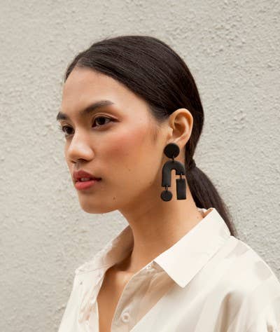 Abstract Earrings shown on model.