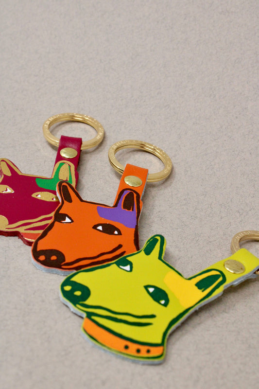 Genuine Leather Dog Keyring. Colourful orange pup with 'best mate' embossed on the reverse. A playful design with a sweet sentiment. Made using the traditional technique of hot foil embossing which ensures a handmade and unique product every time. Made in the UK