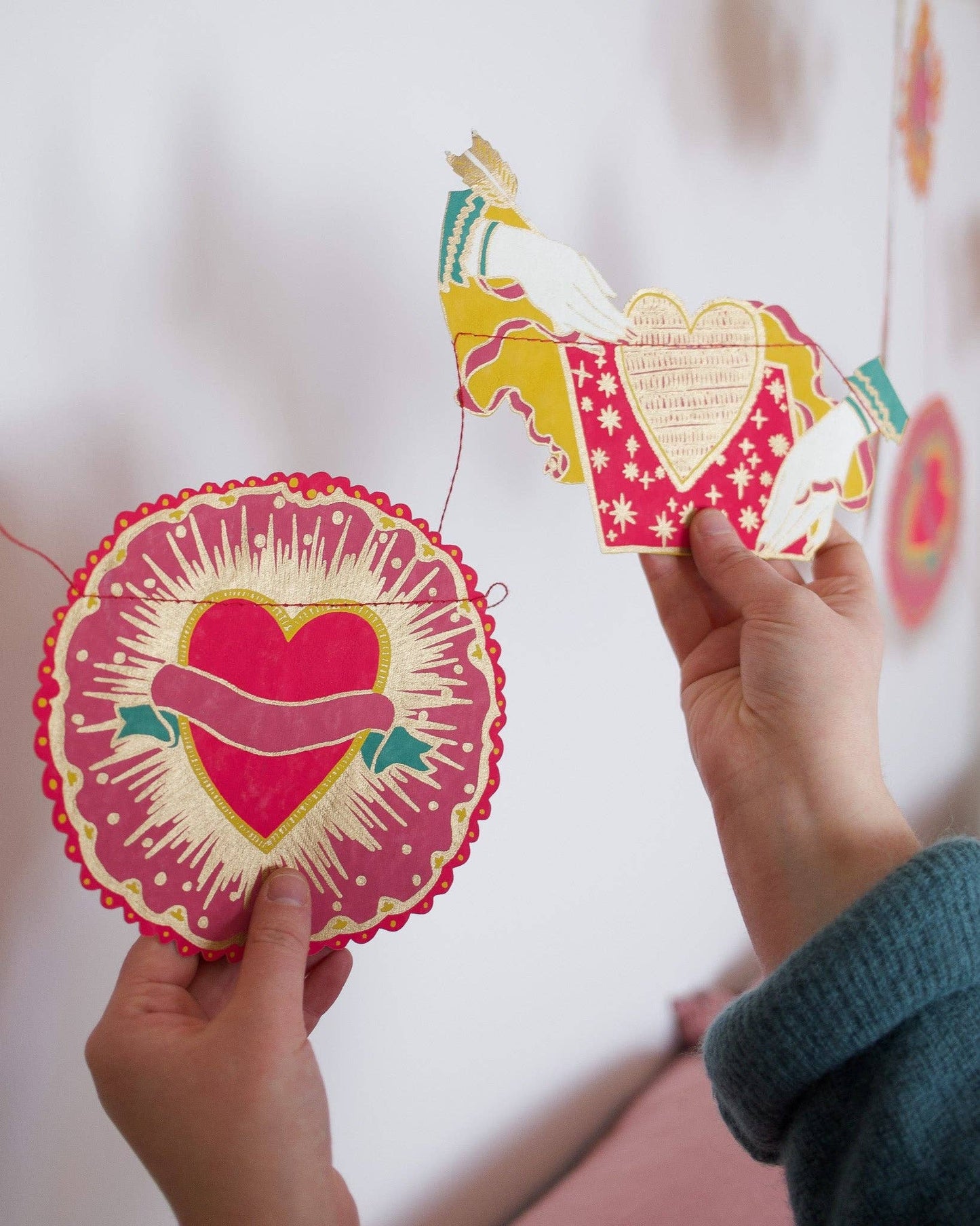 Inspired by scared hearts and Mexican folk art, this garland is full of kitsch and romance. Ten decorative, bejewelled hearts create the three metre garland.

Includes 10 paper shapes, sewn along strong cotton thread - Screen printed by hand on both sides by talented artisans in Jaipur - Sustainably made from recycled materials