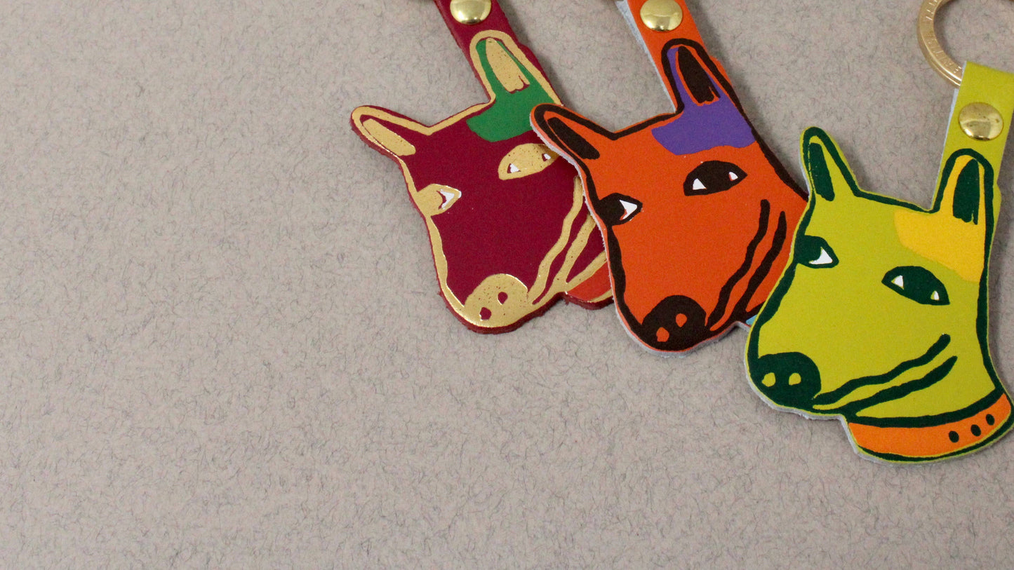 Genuine Leather Dog Keyring. Colourful orange pup with 'best mate' embossed on the reverse. A playful design with a sweet sentiment. Made using the traditional technique of hot foil embossing which ensures a handmade and unique product every time. Made in the UK