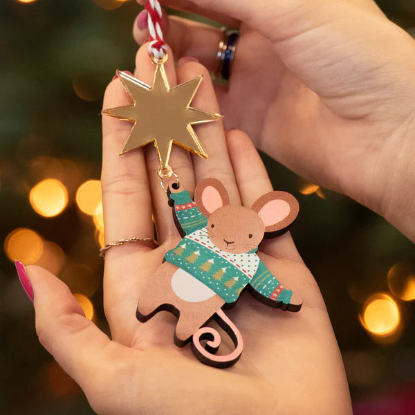 Hand designed decoration mouse wooden wearing and green and white Christmas jumper hanging from a shiny gold star, perfect for Christmas.
Made from sustainably sourced maple wood.