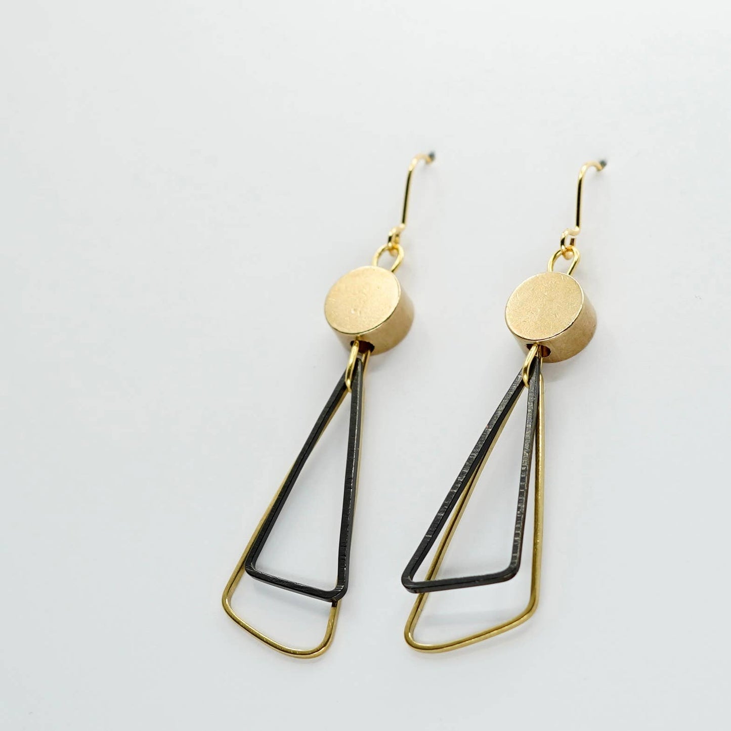 Black + Brass | Triangles Drop Earrings. A striking pair of earrings - two open triangles (one brass, one oxidised black brass) overlap under a brass disc bead.