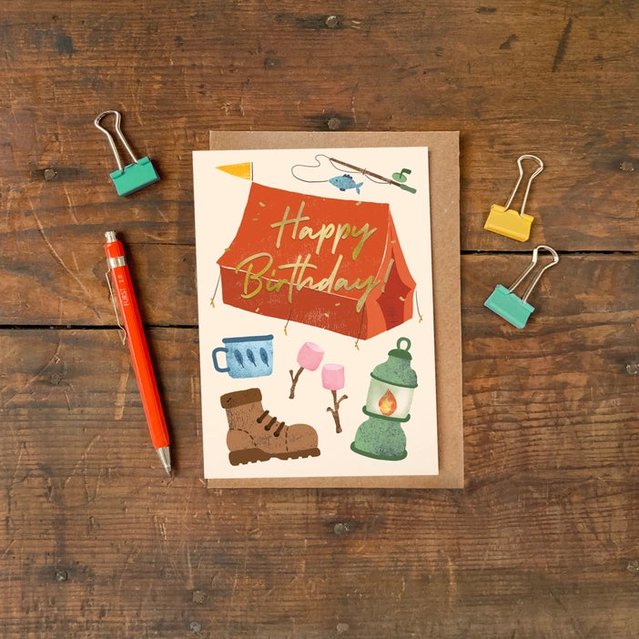 Camping themed birthday greeting card with luxurious gold foiling and a colourful illustration.