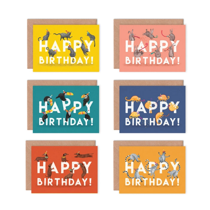 Pack of 6 Illustrated greeting card by Emily Nash Illustration.
Six greeting cards, presented in a cardboard box. Birthday animals include ats, rabbits, toucans, lemurs, sausage dogs, and gekko's. One set of animals per card in their party hats with a bright background.