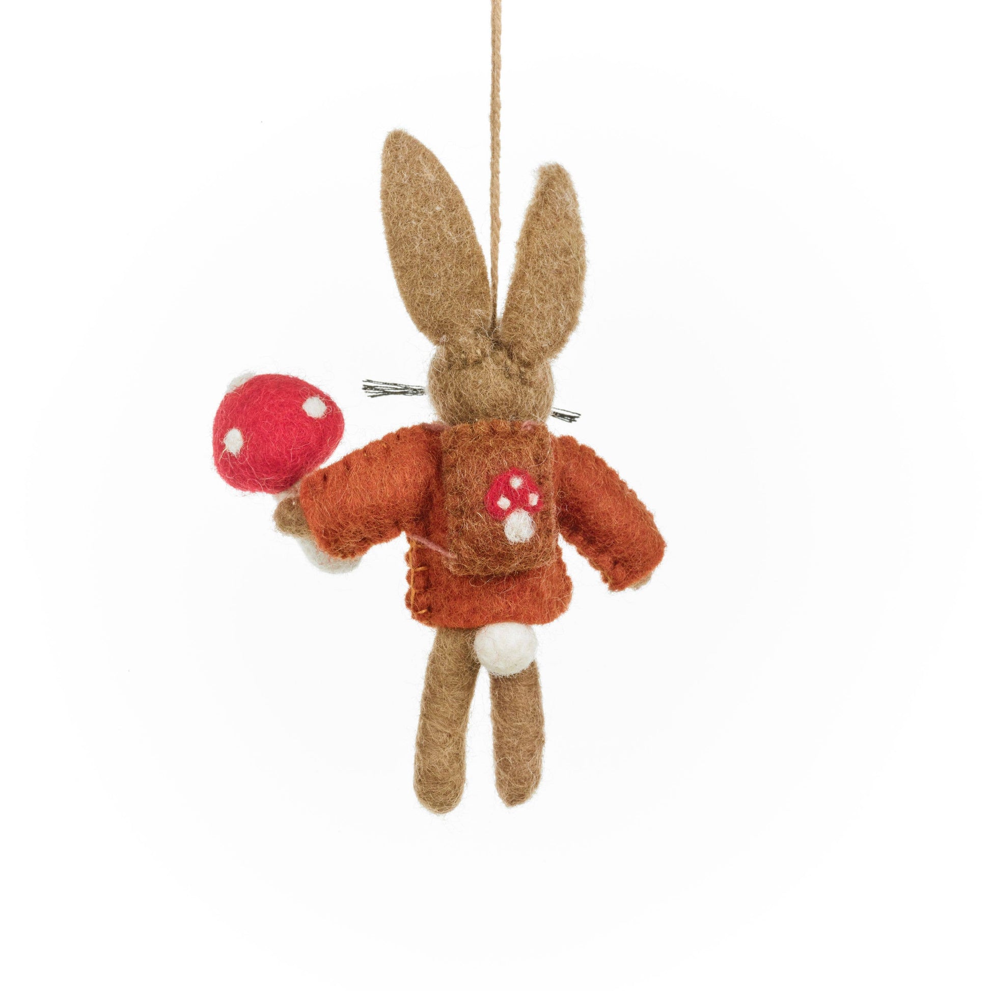 Handmade Felt Autumnal Russell the Hare Hanging Decoration. A hare in a rust coloured jumper, holding a toadstool. Wearing a backpack with a toadstool on it.