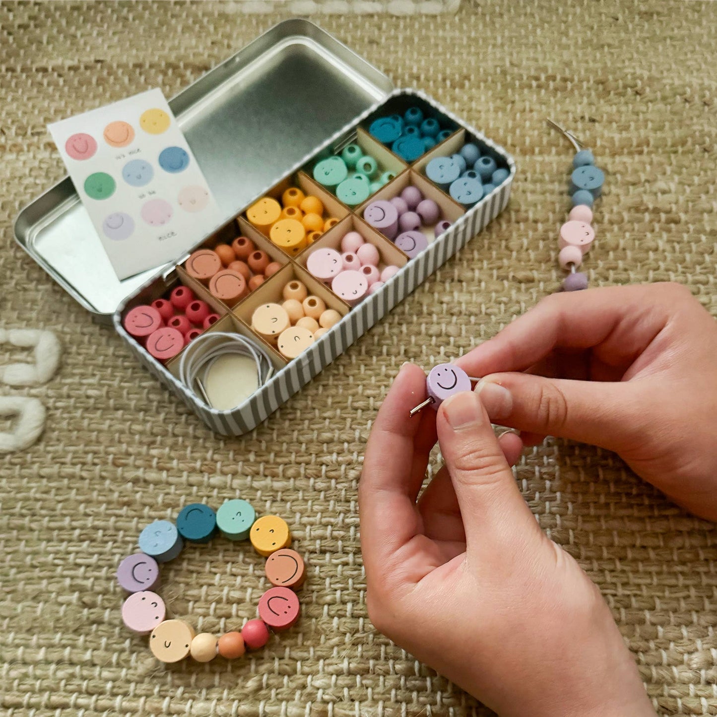 Introducing Cotton Twist's collaborative product: a charming beading set inspired by Abel and the Label's uplifting print, "It's Nice to Be Nice." Crafted with love, this set is more than just a fun activity. We believe that teaching children the value of kindness is essential. Containing enough beads to make 5 beautiful bracelets, a selection of smiley faces and colourful spacer bead await!