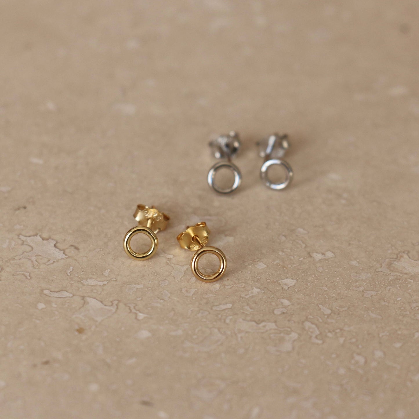 A pair of gold or silver circle studs. 3mm wide