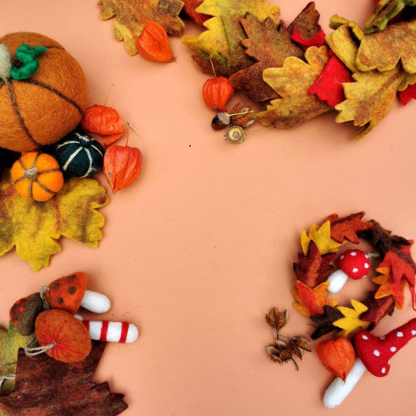 Handmade Felt Autumn Leaves & Toadstool Wreath Decoration. Hanging decoration wreath of leaves with a toadstool in the middle.