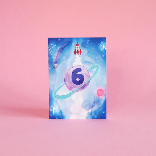 Illustrated 6th birthday card, featuring space rockets, aliens, planets and a galaxy of stars. Sustainably made in the UK