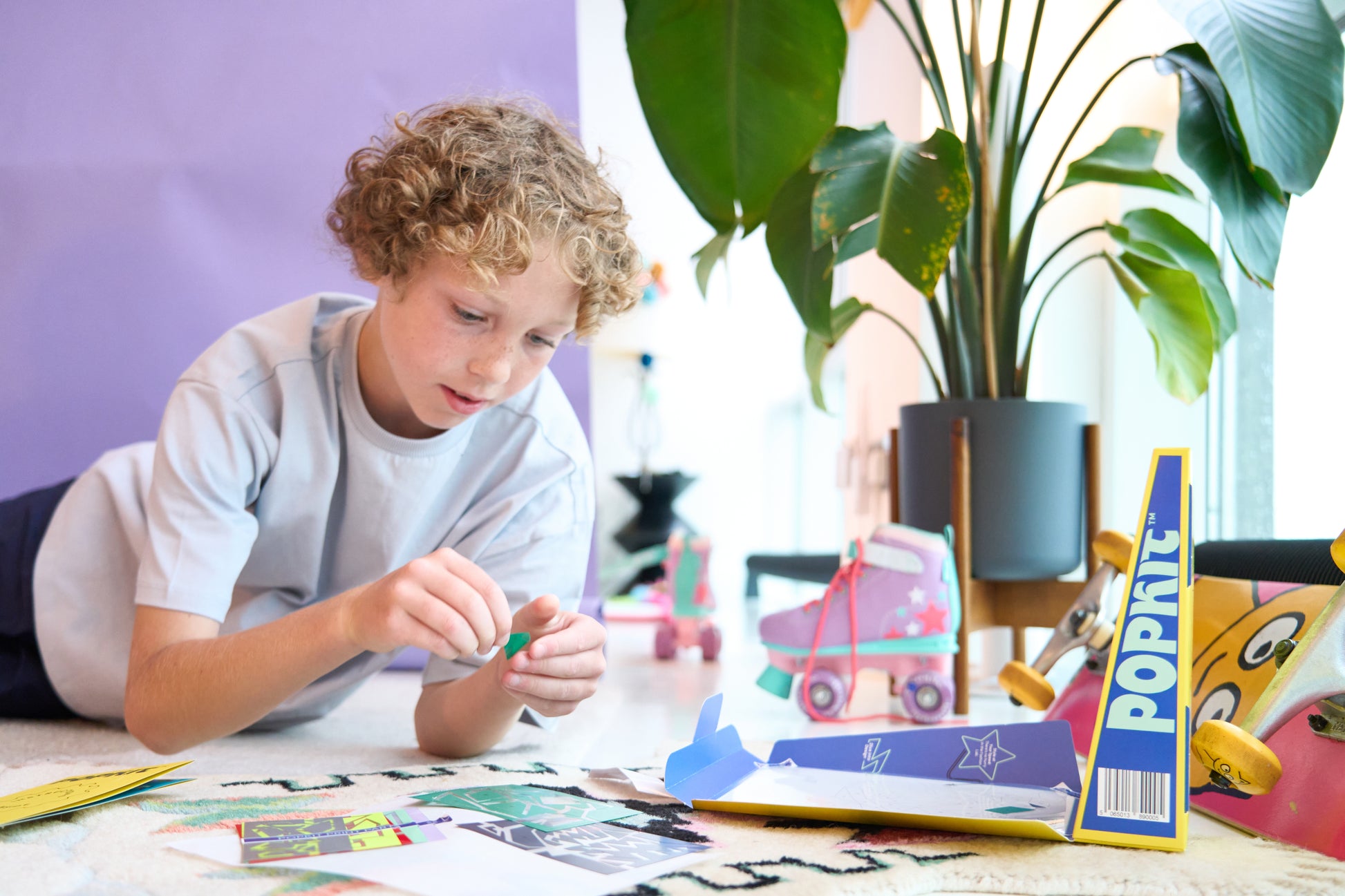 A child with the Dinosaur Pop Kit, assembling the kit.