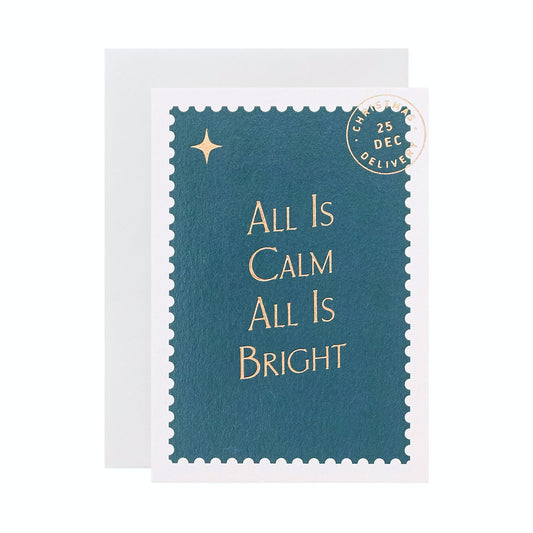 'All Is Calm' Stamp Inspired Christmas Card. Inspired by Festive Postage Stamps, Another Loop's Christmas card collection pays homage to the age-old tradition of sending warm wishes through letters and postcards during the holiday season. Dark blue jewel tones, mottled gold foil and retro typography all encapsulate the magic of communication and connection. A7 with a light grey envelope.