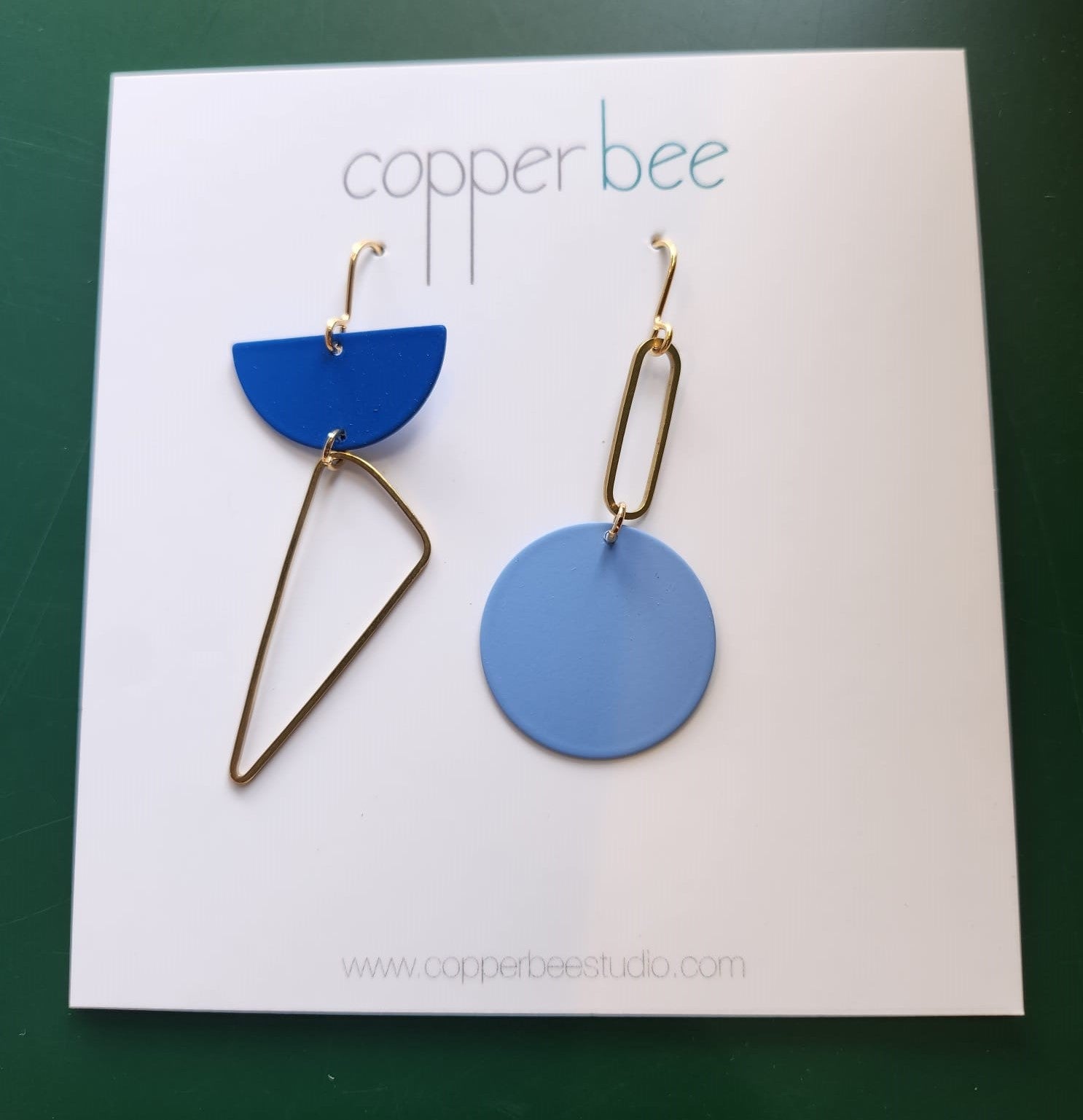 Statement Mismatch Copper Bee Earrings. Handmade in the UK. One earring is Inky Blue  and one is Pale Blue with Brass.