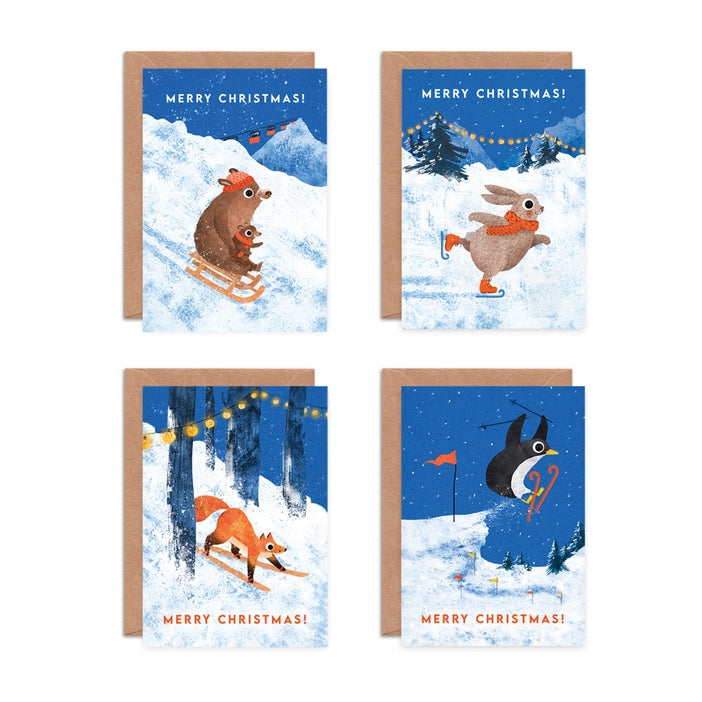 Illustrated Christmas greeting cards by Emily Nash Illustration. Snowy scenes of animals enjoying sledging, ice skating and skiing. With the words Merry Christmas!