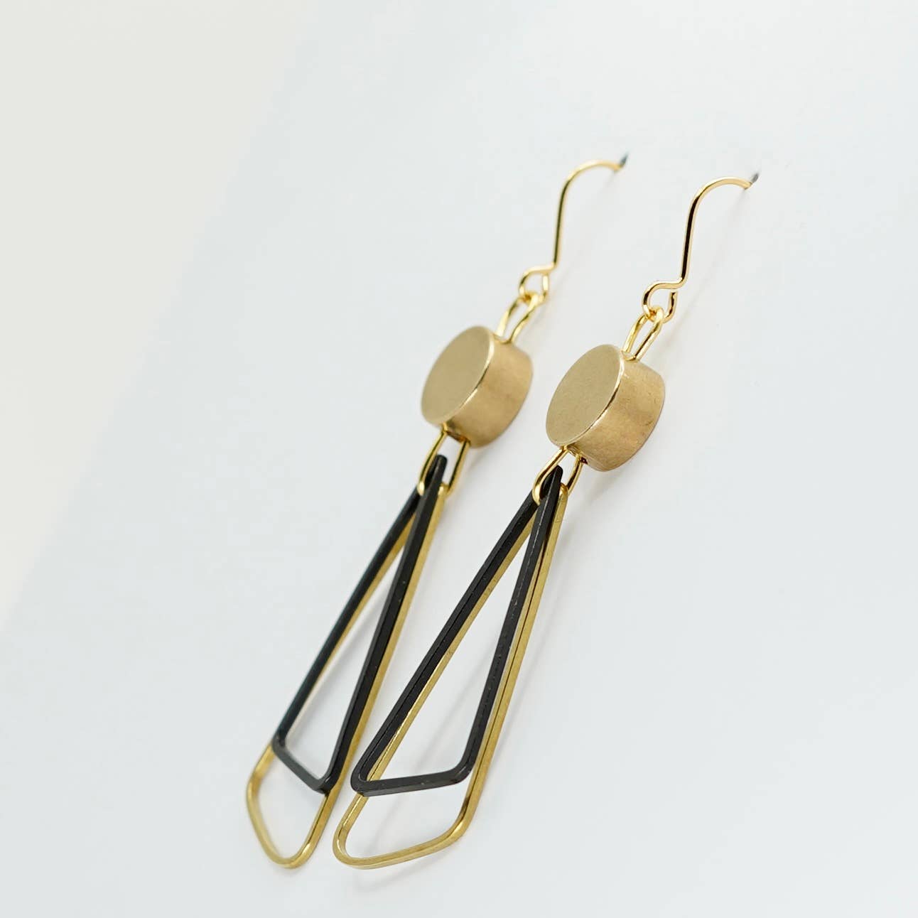 Black + Brass | Triangles Drop Earrings. A striking pair of earrings - two open triangles (one brass, one oxidised black brass) overlap under a brass disc bead.