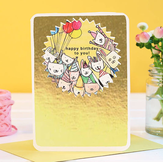 Fabulous gold foiled card with animal friends ready to celebrate your birthday, balloons at the ready and party hats on! With the words Happy Birthday to you!