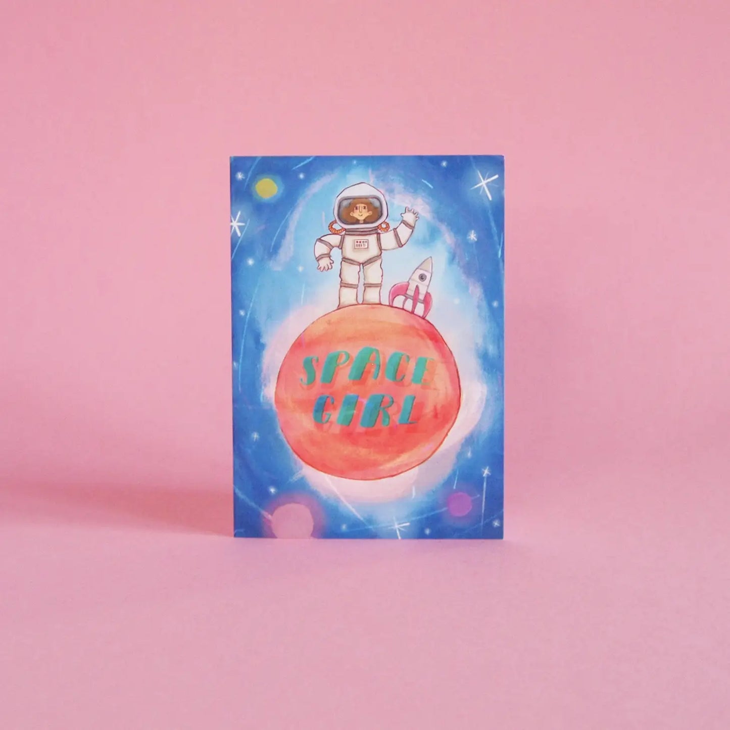 Get ready for lift-off with this illustrated card featuring a girl dressed as an astronaut on the red planet with a rocket. With the words Space Girl.