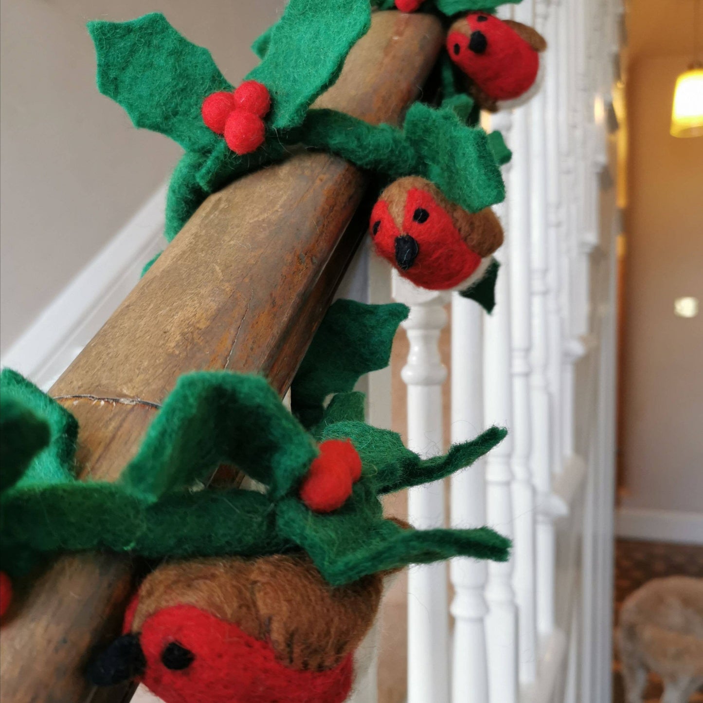 This beautiful holly garland makes for the perfect festive accessory, plus this version comes with three chirpy little friends! Display it on your banister, your mantlepiece or wherever you want to add some funky, felted flair! This timeless decoration is a beautiful take on a Christmas classic - plus, no spikes!

Made entirely by needle and wet felting techniques, with three handmade needle felted birds attached via hand stitching.