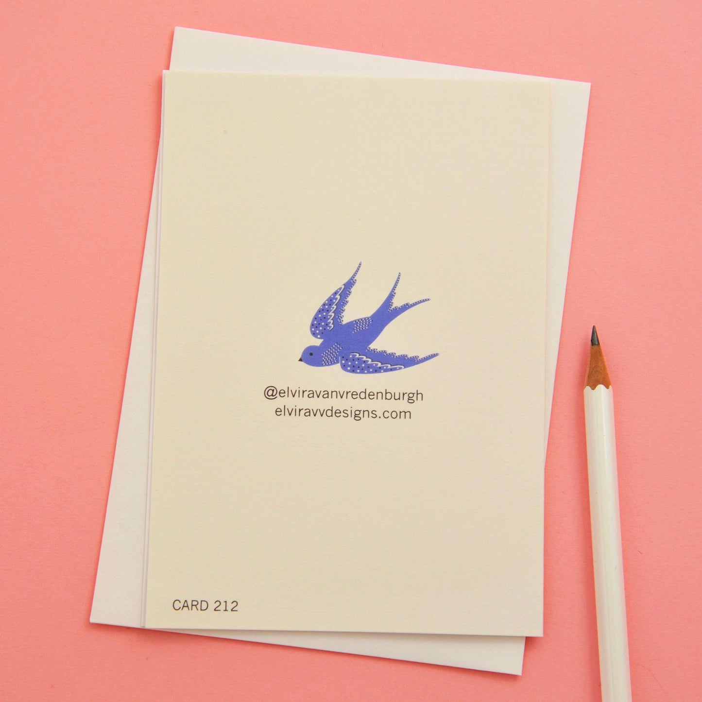 Simple Christmas card depicting a blue dove, a red star and the words Peace & Joy against a white background.