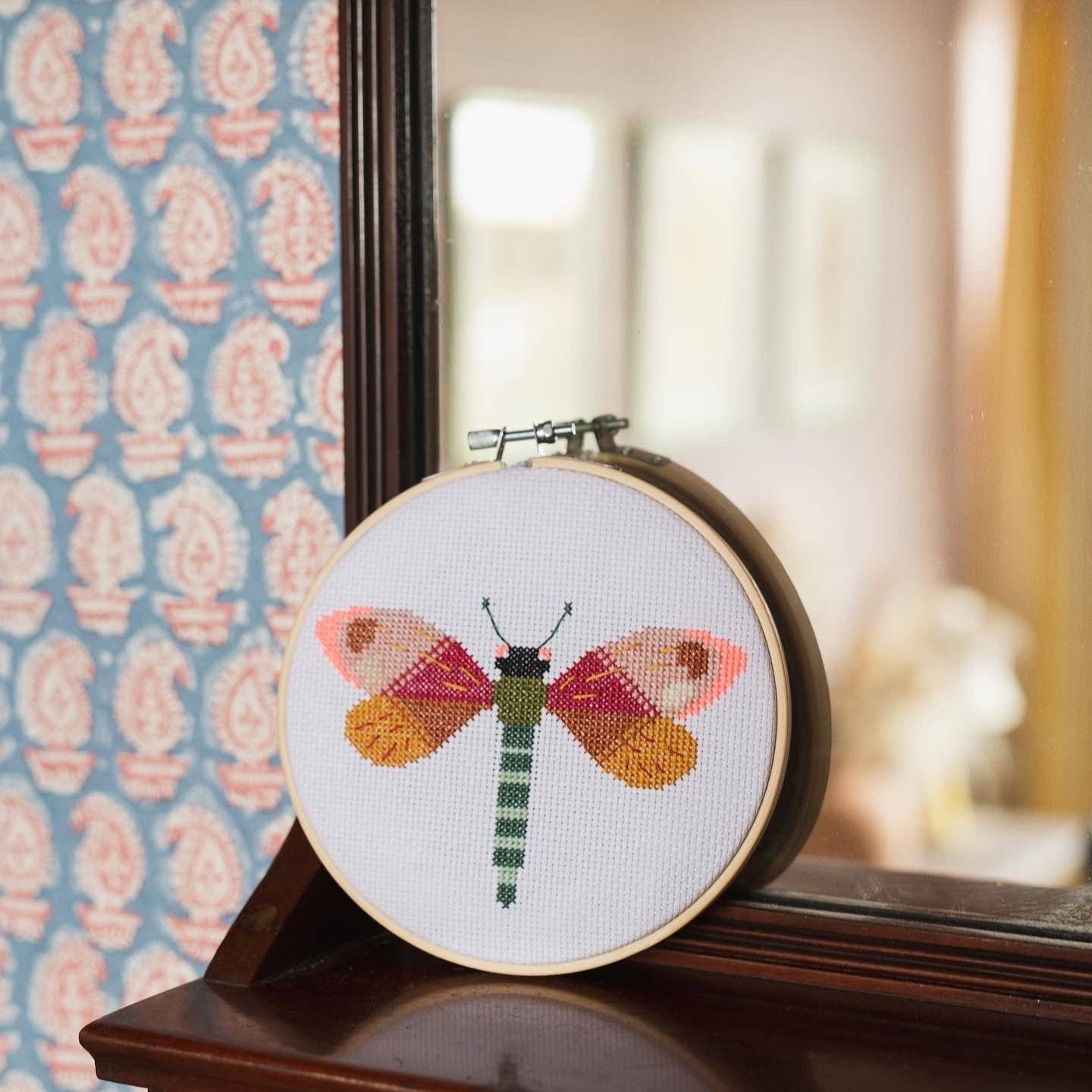 Dragonfly Brie Harrison Cross Stitch Kit. This is a cross stitch craft kit to create a beautiful colourful dragonfly against a white aida.