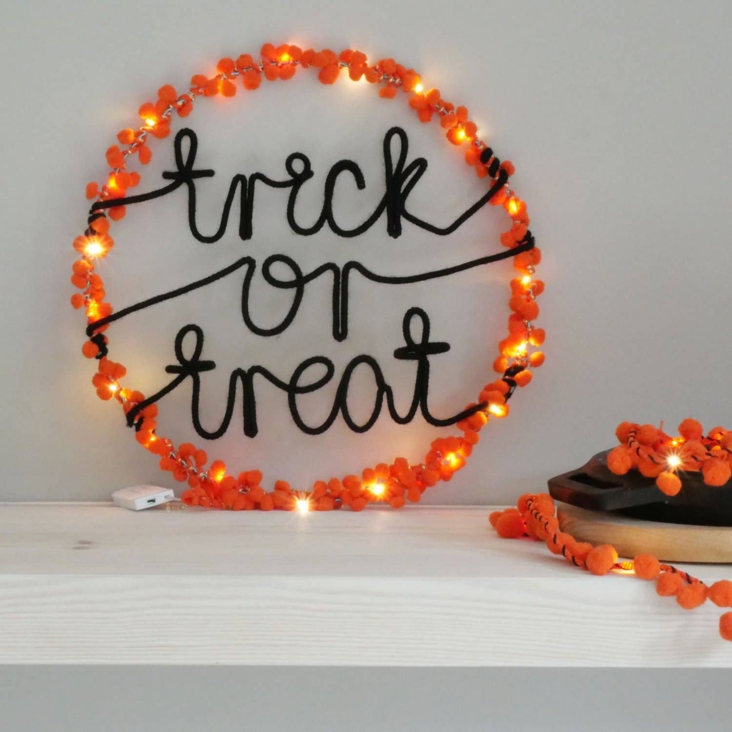 Lively orange pom poms design, these light-up Trick or Treat hoops are sure to set the mood for a memorable Halloween celebration. 