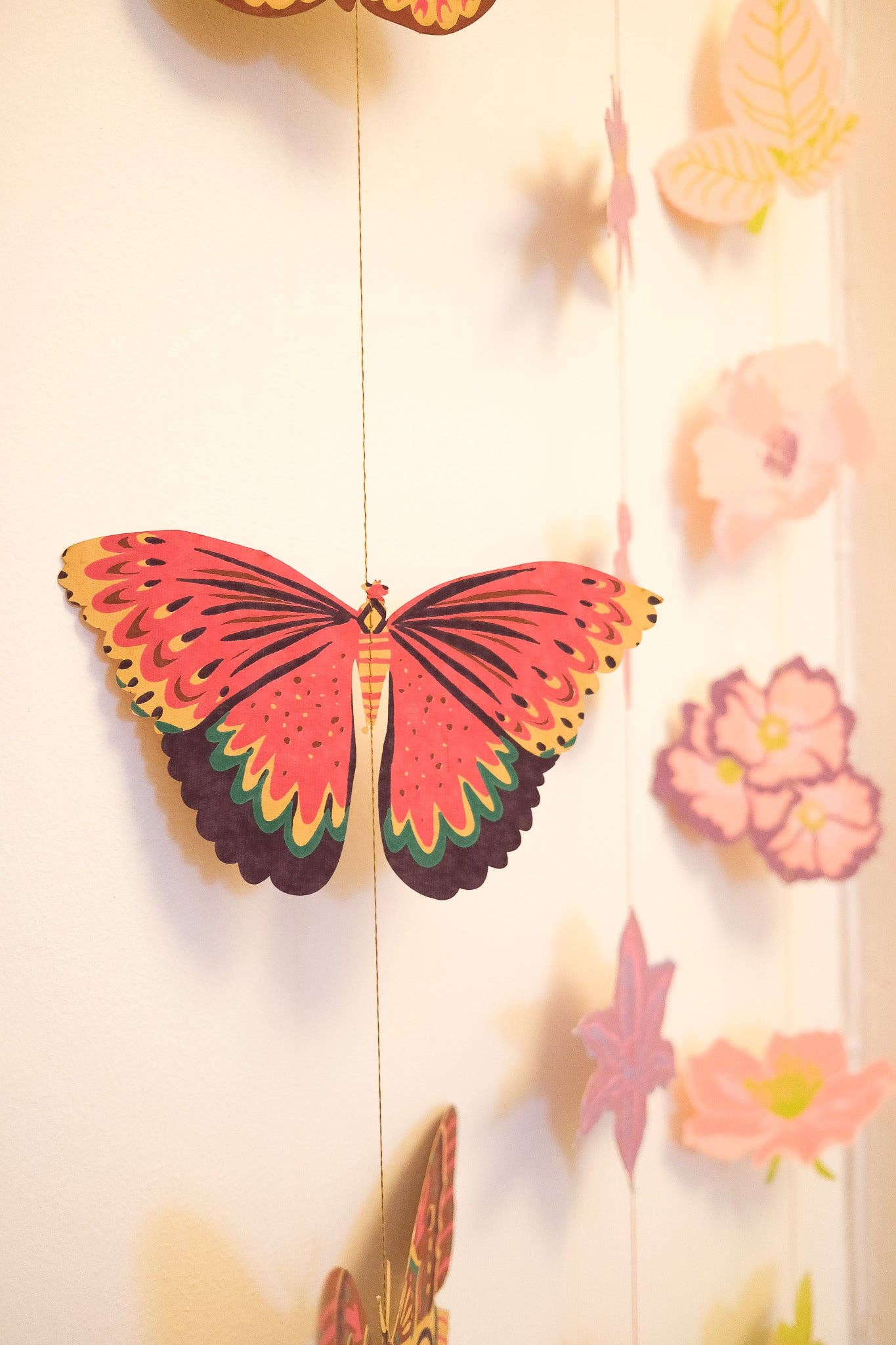 East End Press Delicate butterflies with fluttering wings bring colour and joy to your home in this two-metre-long wall hanging.

2 metres long Butterfly paper shapes are sewn along a strong cotton thread Screen printed by hand on both sides by talented artisans in Jaipur Sustainably made from recycled materials