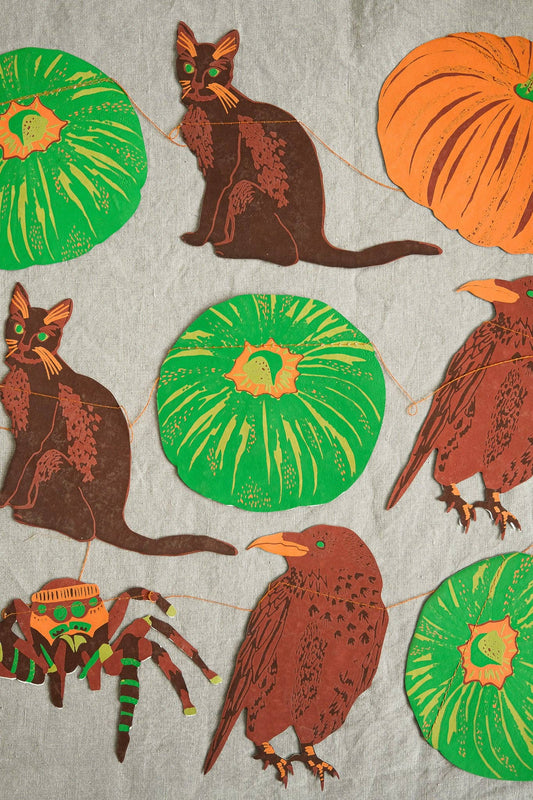 In bold greens and bright oranges, this garland features all the traditional images of Halloween - cats, ravens, spiders and pumpkins!
3 metres long - Includes 10 paper shapes, sewn along strong cotton thread