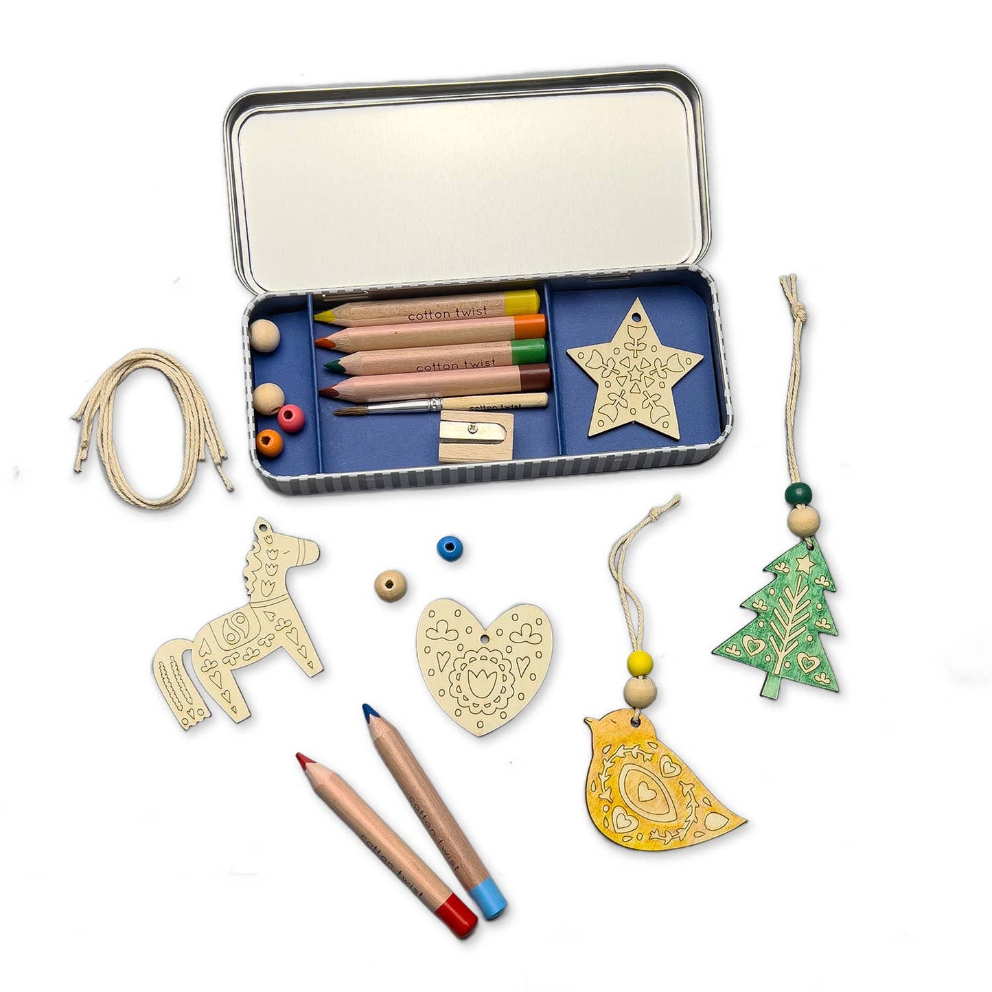 Folk Art Decoration kit. This kit features five wooden decorations to make, perfect for adding a touch of handcrafted beauty to a Christmas tree or any festive display. Along with the wooden decorations, the kit includes a selection of watercolour pencils and wooden beads, allowing for each decoration to be personalised with a touch of folk art charm.