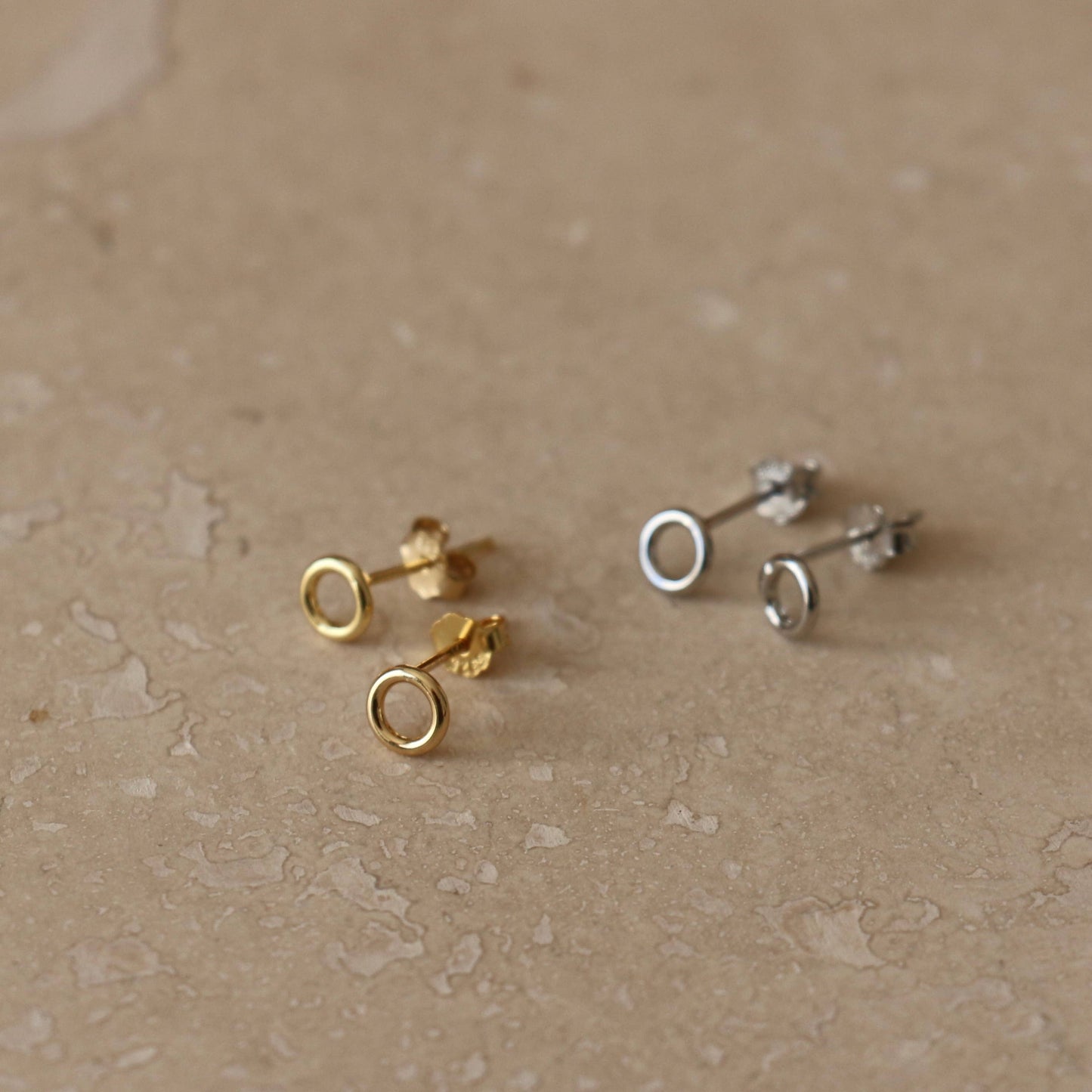 A pair of gold or silver circle studs. 3mm wide.