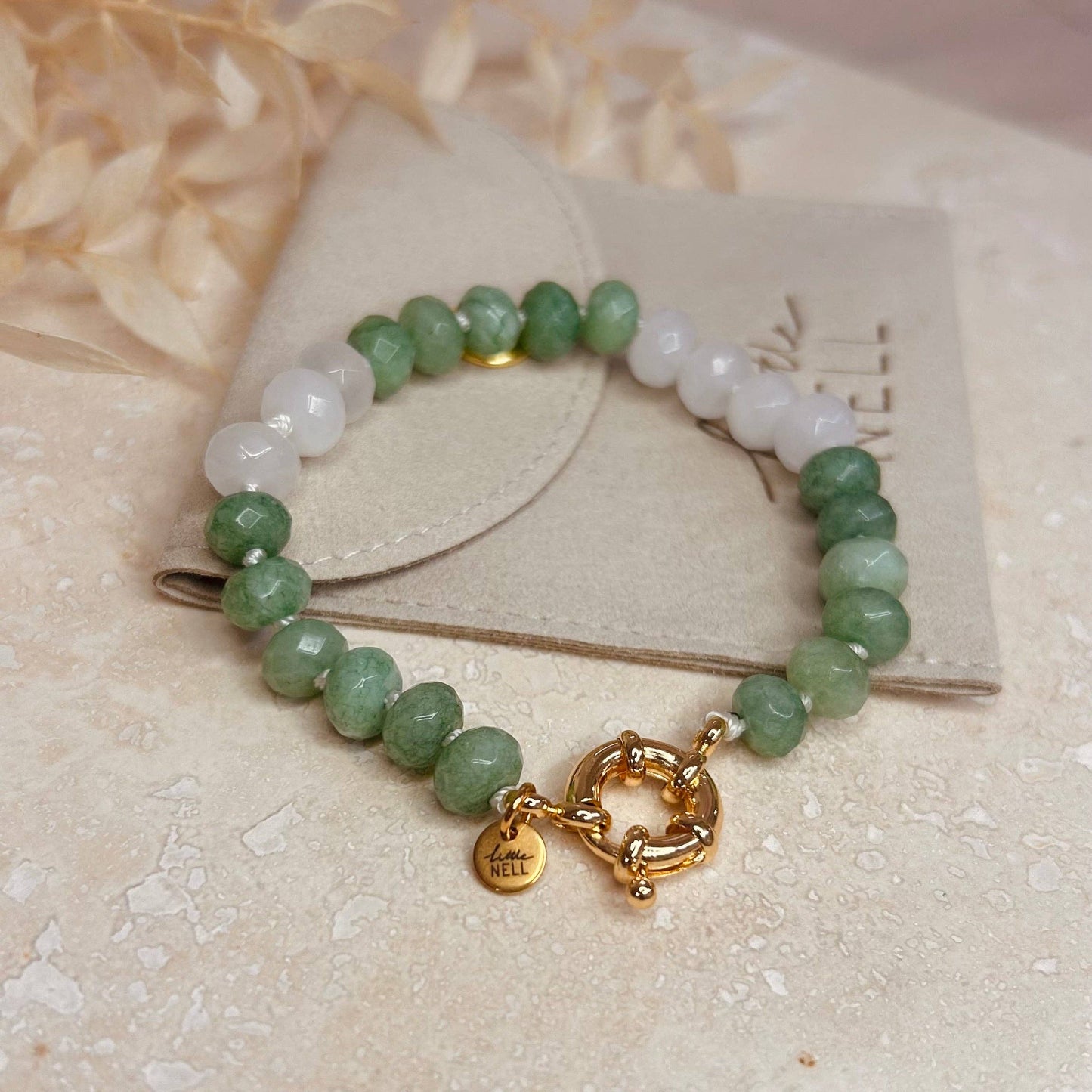 A green glass beaded bracelet, a simple, elegant design when worn alone, or can be stacked for a bolder statement look.

18k gold plated bracelet.