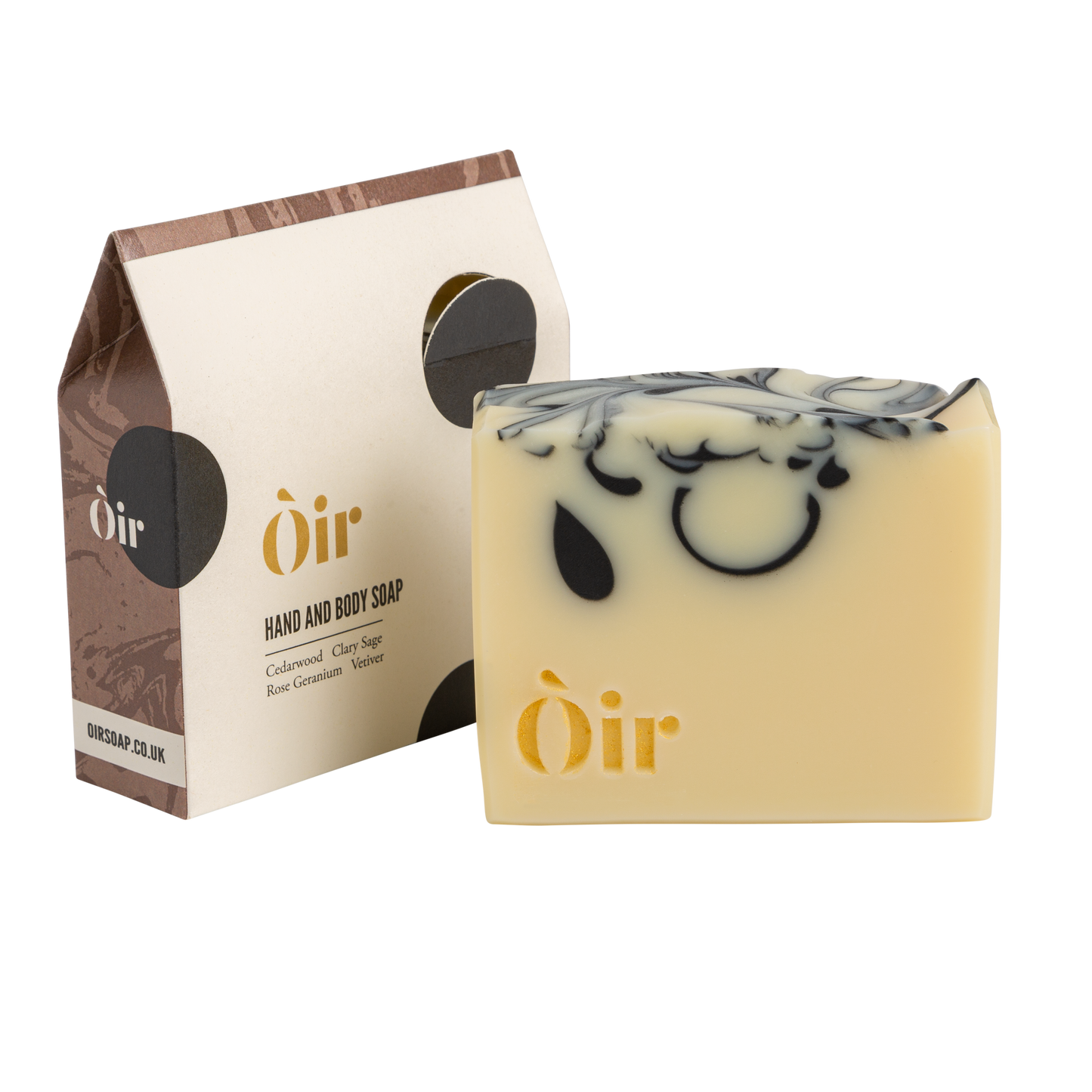 Cedarwood, Clary Sage, Rose Geranium and Vetiver Soap. Handmade in the UK. A sustainable replacement for shower gel. The soap is a cream bar with beautiful, gold lettering with the word OIR| and black swirls in the soap.