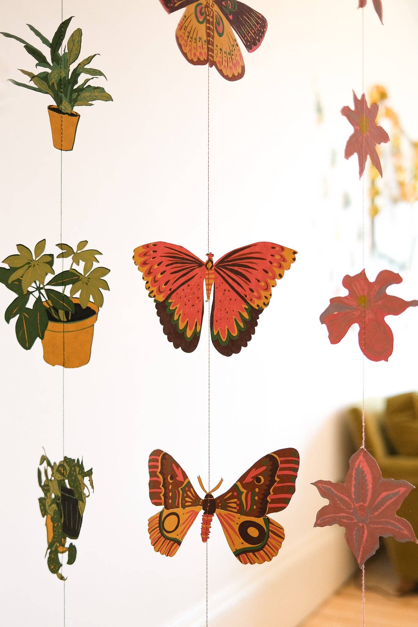 East End Press Delicate butterflies with fluttering wings bring colour and joy to your home in this two-metre-long wall hanging.

2 metres long Butterfly paper shapes are sewn along a strong cotton thread Screen printed by hand on both sides by talented artisans in Jaipur Sustainably made from recycled materials