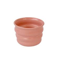 Handcrafted Ripple Beaker in Pink. Handcrafted from stoneware clay, this colourful ceramic beaker with distinctive ripple texture is ideal for your morning coffee, a wine with friends or even a good old cup of water. The quirky rippled form provides a playful aesthetic whilst also being extremely ergonomic to hold, perfect for slotting your fingers comfortably into the grooves. 7 cm high and 9cm wide at the rim.