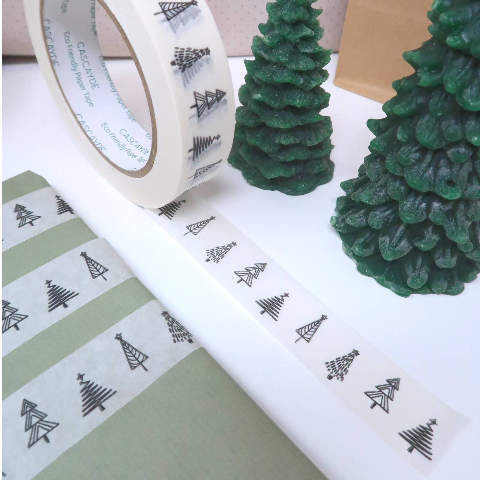 Christmas Forest Paper Tape 24mm. White paper tape featuring different styles of Christmas trees in black  vegan ink. Recyclable.