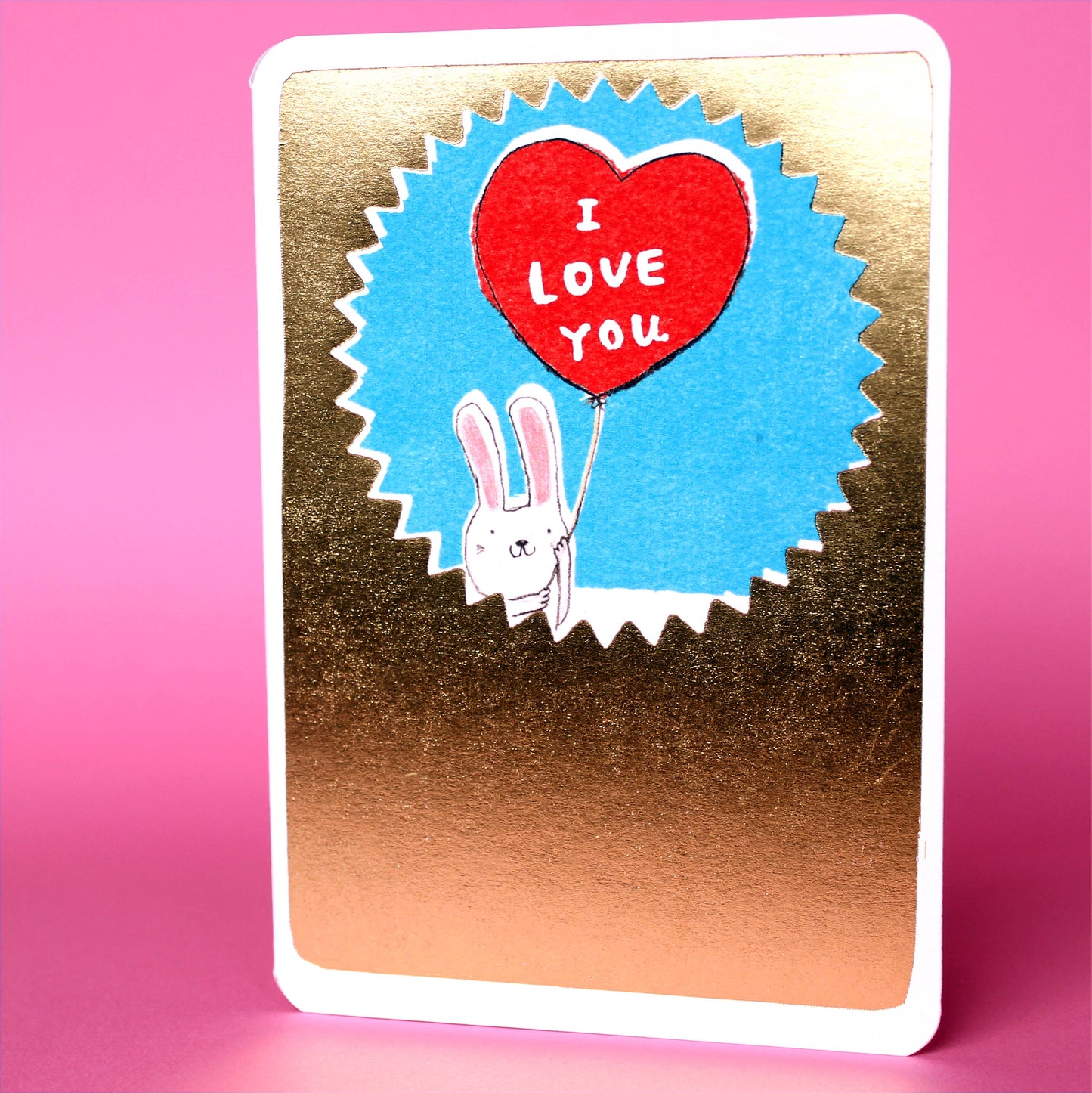 Gold I Love You Bunny Valentine Card. Why not express your love with this adorable bunny and a big, shiny heart balloon? It's the perfect way to say "I love you" this Valentine's Day.