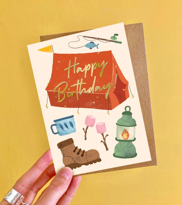 Camping themed birthday greeting card with luxurious gold foiling and a colourful illustration.