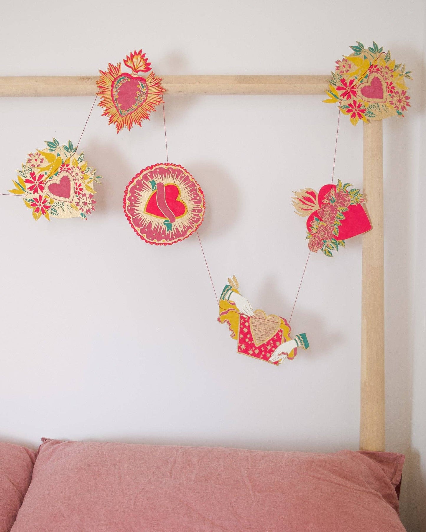 Inspired by scared hearts and Mexican folk art, this garland is full of kitsch and romance. Ten decorative, bejewelled hearts create the three metre garland.

Includes 10 paper shapes, sewn along strong cotton thread - Screen printed by hand on both sides by talented artisans in Jaipur - Sustainably made from recycled materials