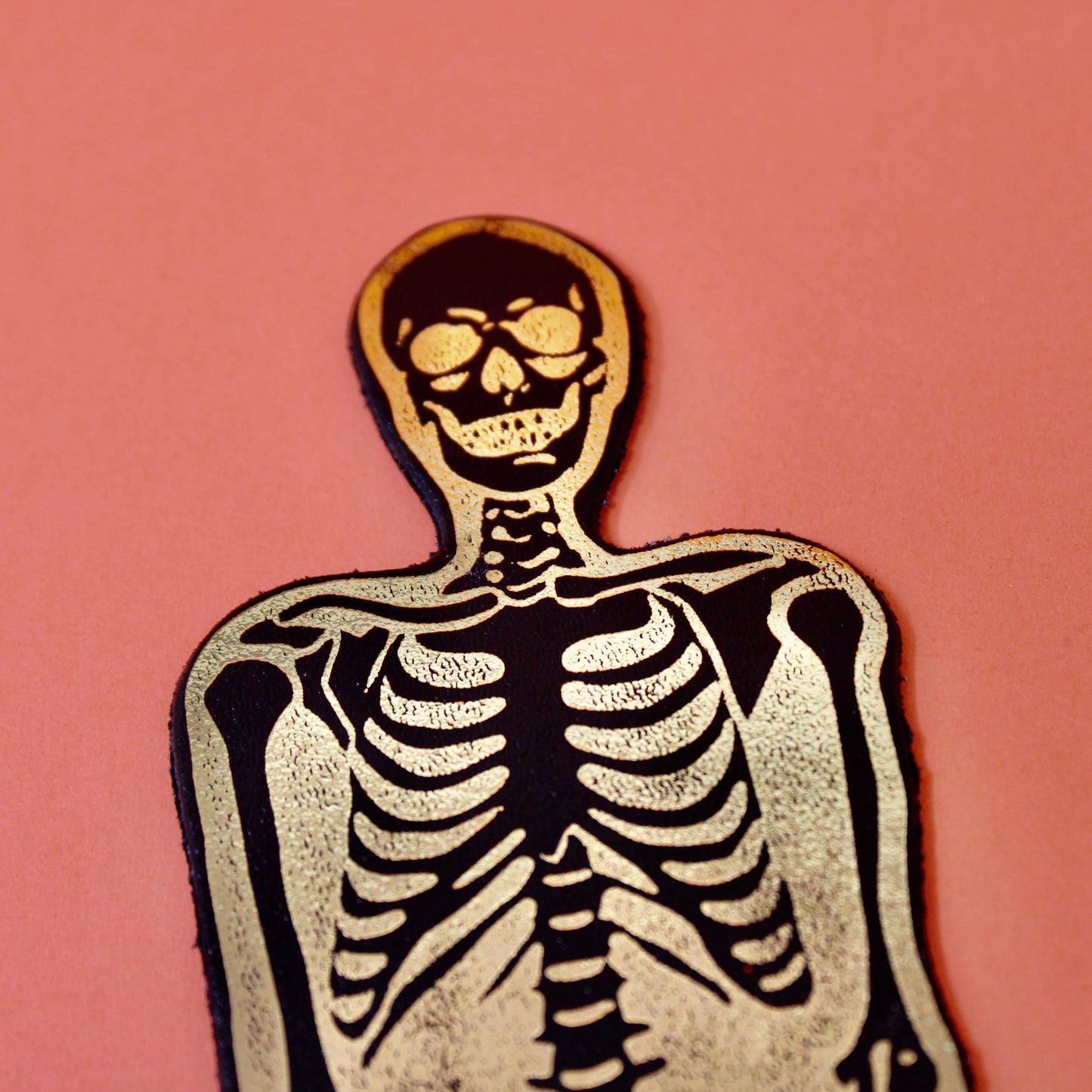 A spooky skeleton leather bookmark embossed with ‘You read right through me’ on the reverse.